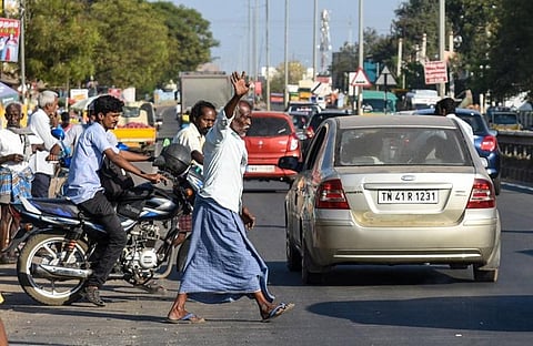 Pedestrians cross the Tiruchy-Thanjavur National Highway dangerously in the absence of a service road. (Photo | MK Ashok Kumar, EPS)