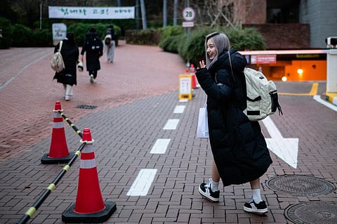 South Korean singer and actress Kang Ye-seo, known as Yeseo, arrives to sit for the annual college entrance exam, known locally as Suneung, in Seoul on Nov 16, 2023. (AFP)
