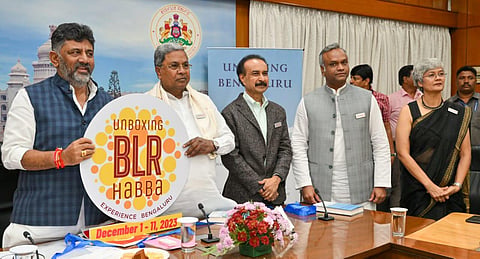 Deputy CM DK Shivakumar and Chief Minister Siddaramaiah unveil the logo of ‘Unboxing Bengaluru Habba’ on Thursday. Minister Priyank Kharge looks on. (Photo | Express)