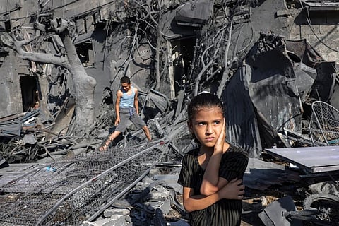 A girl looks on as she stands by the rubble outside a building that was hit by Israeli bombardment in Rafah in the southern Gaza Strip on October 31, 2023. (Photo | AFP)