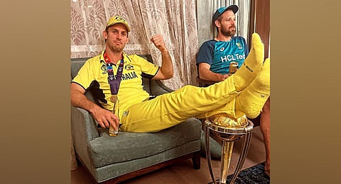 The image of Australian cricketer Mitchell Marsh with his legs on top of the ICC Cricket World Cup trophy which sparked an outrage among Indian fans. (Photo | Instagram)