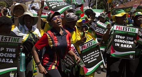 Pro-Palestinian supporters demonstrate at the entrance to the Israeli embassy in Pretoria, South Africa, Friday, Oct. 20, 2023.