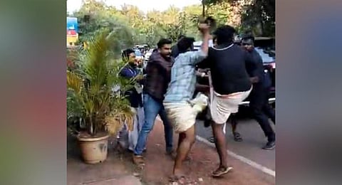 A video grab shows a Youth Congress worker being beaten up for attempting to wave a black flag at CM’s vehicle at Pazhayangadi in Kannur on Monday.