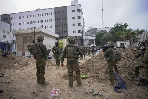 Israeli soldiers stand outside Shifa Hospital in Gaza City. (Photo | AFP)