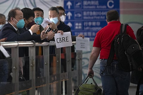 People wait at the international passenger arrivals area at Beijing Capital Inernational Airport in Beijing. (Photo | AP)