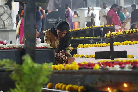 A woman is seen paying respect at Narayanguda burial ground on 'All Souls Day' in Hyderabad. (Photo | Sri loganathan Velmurugan)