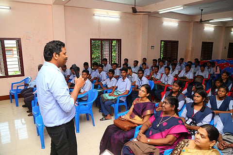 Karaikal District Collector A Kulothungan addressing the students on inauguration of free NEET coaching on Saturday. (Photo | Express)