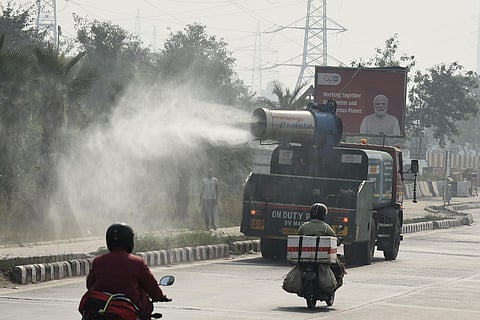 An anti-smog gun sprinkling water to make dust particles settle amid a rise in pollution levels on November 6, 2023, in New Delhi. (Parveen Negi)
