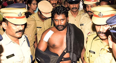 Maradu Aneesh with police personnel at Medical Trust Hospital in Kochi on Wednesday. (Photo | A Sanesh, EPS)