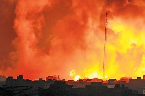 Fire and smoke rises from buildings following Israeli airstrikes on Gaza City.(Photo | AP)