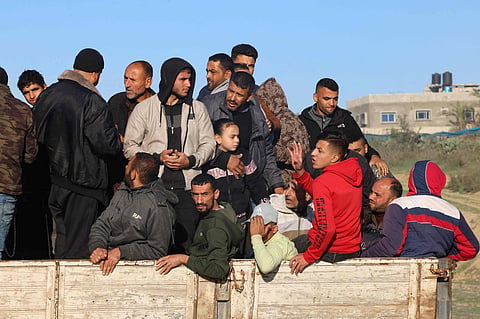 Palestinians flee Khan Yunis in southern Gaza Strip further south toward Rafah, along the Salah Al-Din road, on December 10, 2023. | AFP