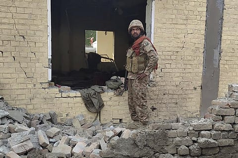 An army soldier examines damages on the site of a bombing at a police station on the outskirts of Dera Ismail Khan, Pakistan, Tuesday, Dec. 12, 2023. (Photo | AP)