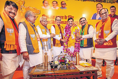Madhya Pradesh CM-designate Mohan Yadav being greeted by outgoing CM Shivraj Singh Chouhan, state BJP chief V D Sharma and others in Bhopal on Monday | pti
