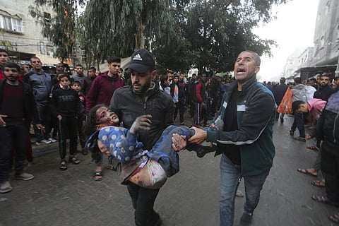 Palestinians evacuate survivors of the Israeli bombardment of the Gaza Strip in Rafah on Tuesday, Dec. 12, 2023. (Photo | AP)