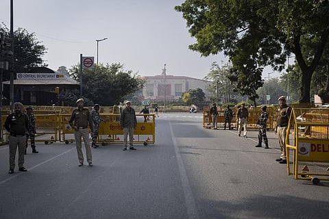 Security officers stand guard at a checkpoint outside the Indian parliament in New Delhi, a day after the security breach in Lok Sabha, Dec. 14, 2023. (Photo | AP)