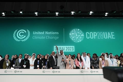 Officials pose for photos at the end of the COP28 UN Climate Summit, Wednesday, Dec. 13, 2023, in Dubai, UAE. (AP Photo)