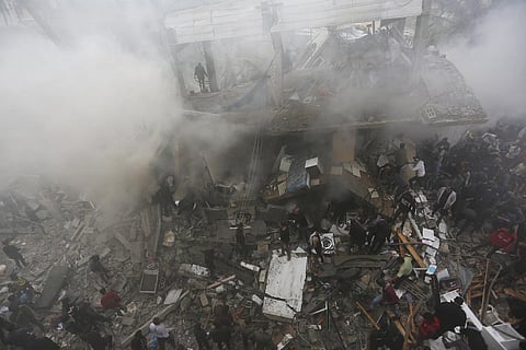 Palestinians look for the survivors of an Israeli strike in Rafah, Gaza Strip, Thursday, Nov. 14, 2023. (AP Photo)