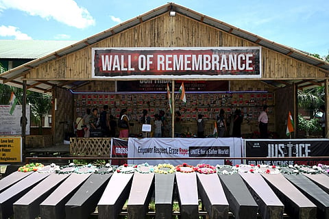 FILE - People look at portraits of victims who lost their lives during ethnic clashes, as empty coffins are kept at a memorial in Churachandpur district, Manipur, July 24, 2023. (AFP Photo)