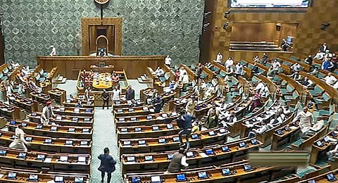 A visitor jumps in the Lok Sabha chamber from the public gallery during the Winter session of Parliament, in New Delhi, Wednesday, Dec. 13, 2023. (PTI)