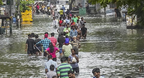 FILE: People wade through a waterlogged road after heavy rainfall owing to Cyclone Michaung, in Chennai, Tuesday, Dec. 5, 2023. (PTI Photo)