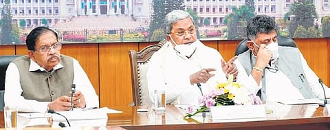 CM Siddaramaiah addresses reporters after the Covid-19 TAC meeting, in Bengaluru on Thursday. DyCM DK Shivakumar and Home Minister Dr G Parameshwara look on