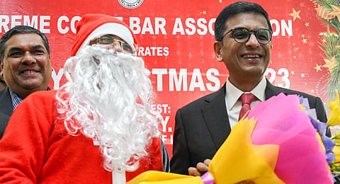 Chief Justice of India (CJI) Justice DY Chandrachud being felicitated with a bouquet during the Christmas Day programme, at the Supreme Court of India (SCI), in New Delhi on Monday. (Photo | ANI)