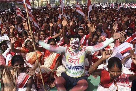 Tribals wearing traditional attire take part in a Maharally demanding separate 'Sarna Dharm Code' for tribals, at Morhabadi grounds in Ranchi, on Mar 12, 2023. (Photo | PTI)