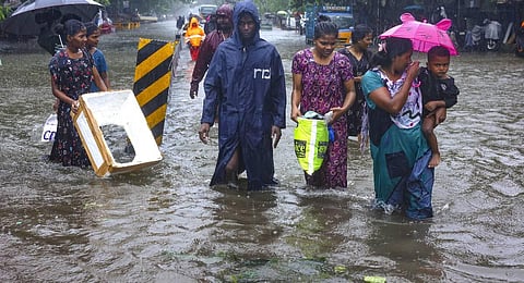People wade through a waterlogged road after heavy rainfall owing to Cyclone Michaung, in Chennai, Tuesday, Dec. 5, 2023. (PTI Photo)
