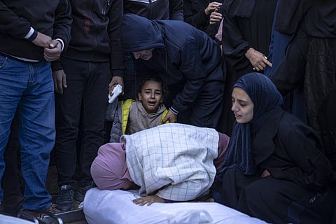 Palestinians mourn their relatives killed in the Israeli bombardment of the Gaza Strip, in the hospital in Khan Younis last month (AP)
