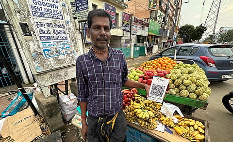 P Prakash, a fruit seller in Nolambur says he has not faced any disruptions in the UPI payments since Tuesday. (Photo| Sunish P Surendran, EPS)