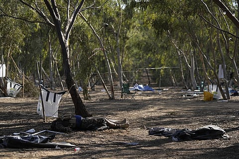 The body of a killed Hamas militant lies on the ground at the site of a music festival, near the border with the Gaza Strip in southern Israel. (Photo | AP)