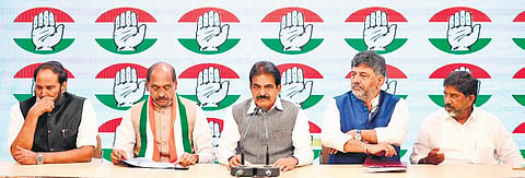 Congress MP Uttam Kumar Reddy (left) appears to be in deep thought as AICC general secretary KC Venugopal addresses the media in New Delhi on Tuesday