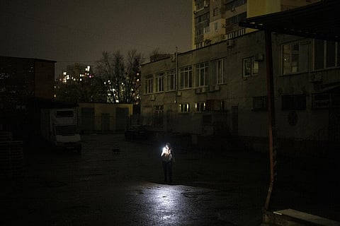 A woman uses her phone to light her way in Kyiv, Ukraine, Tuesday, Jan. 31, 2023. ( Photo | AP)