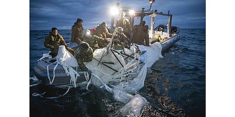 US Navy sailors recover the high-altitude Chinese surveillance balloon off the coast of Myrtle Beach, South Carolina, in the Atlantic Ocean, Feb 5, 2023. (Photo | AFP)