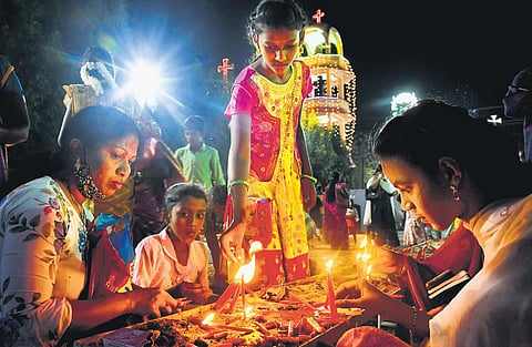 Devotees lighting up candles as they offer prayers to Mother Mary during the festival at Gunadala in Vijayawada on Friday I Prasant Madugula