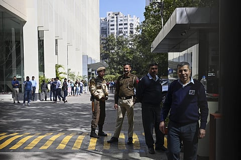 A police officer stands at the entrance of the office building where the income tax authorities raided the BBC's office in New Delhi on February 14, 2023. (Photo | AFP)
