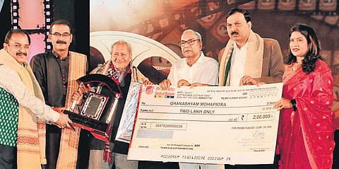 Tourism Minister Aswini Patra presenting Jayadev Puraskar to Ghanashyam Mohapatra at the 31st Odisha State film award on Monday | Shamim Qureshy