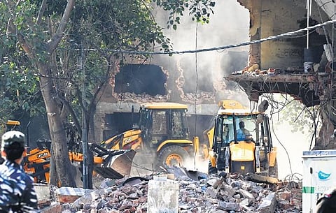 Heavy machinery being used to demolish alleged illegal structures during an anti-encroachment drive by DDA in Mehrauli on Tuesday | shekhar yadav