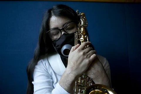 Maria Elena Ríos holds her saxophone at the end of a rehearsal at the National Autonomous University of Mexico music department, in Mexico City, Tuesday, Feb. 14, 2023. (Photo | AP)