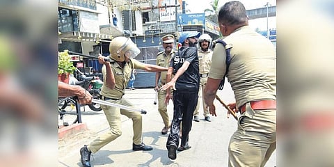 Police using lathi against Congress workers at Kalamassery on Tuesday | Express