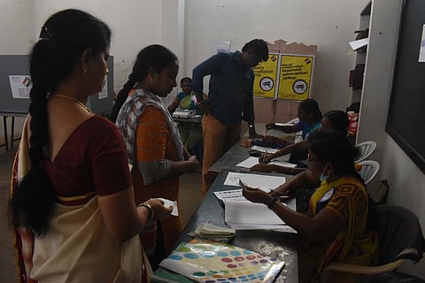 Constituents line up to vote at a polling station in Erode, for the Erode East constituency by-election, on Monday. (Photo | S Senbagapandiyan, EPS)
