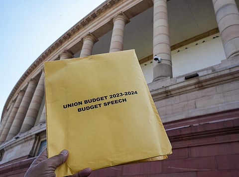 A copy of Union Budget 2023-24 in the backdrop of the Parliament House in New Delhi, Wednesday, Feb. 1, 2023. (File Photo | PTI)