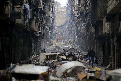 Residents walk through the destruction of the once rebel-held Salaheddine neighborhood in the eastern Aleppo, Syria, Friday, Jan. 20, 2017. (Photo | AP)