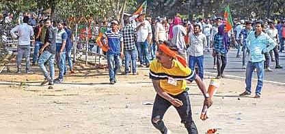A protester hurls stones at police near MG Marg in Bhubaneswar | DEBADATTA MALLIK