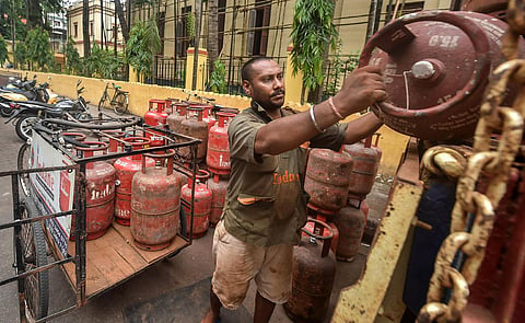 A worker unloads domestic LPG gas cylinders from a truck. (File Photo | PTI)