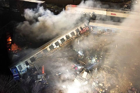 Smoke rises from trains as firefighters and rescuers operate after a collision near Larissa city, Greece, early Wednesday, March 1, 2023. (Photo | AP)