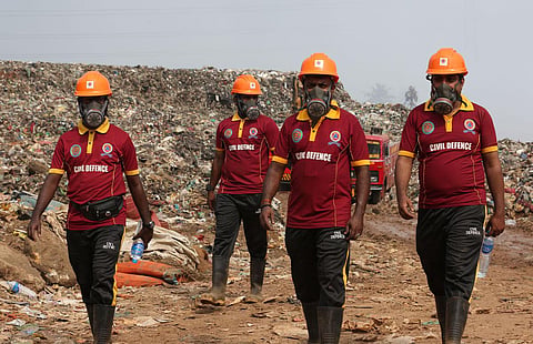 Civil Defence volunteers engaged in firefighting operations at Brahmapuram on Thursday. (Photo | T P Sooraj, EPS) 