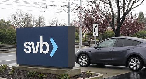 A car drives past a Silicon Valley Bank sign at the company's headquarters in Santa Clara. (Photo | AP)