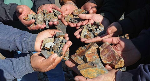Villagers show lithium stones in Reasi district. (Photo | PTI)
