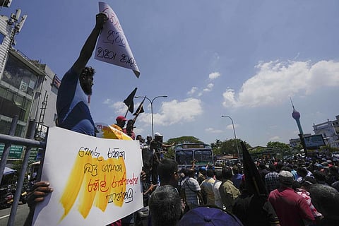 Sri Lankans shout slogans during a protest against the government increasing income tax to manage day to day expenses amid an economic crisis in Colombo. (Photo | AP)